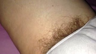 The pubic hair of my wife sticking out of her panties