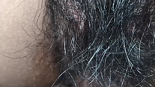Close up view on a hairy and creamy pussy
