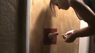 Girlfriend serving a cock through a Gloryhole