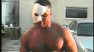 Muscular Stranger in White Superhero Mask Drills Ebony Chick on the Parking of Shopping Mall