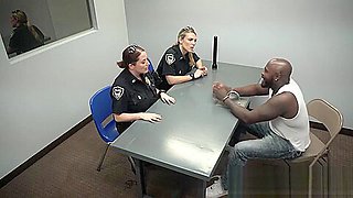 A black stud is under interrogation by two horny and busty MILFs craving for sex