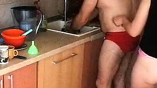 Couple Having Fun in the Kitchen. Sexy Wife Doing Chores in the House Naked