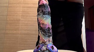 Busty ebony slut stains the camera squirting as she rides a dildo