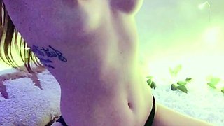 Young redhead in black panties poses seductively on webcam