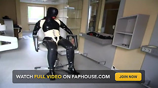 Masked redhead in latex gets tied up