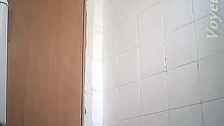 Fine curvaceous blonde lady in white dress filmed in the toilet room