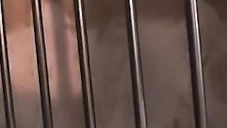 Brunette and a Blonde Manage to Fuck Each Other with a Strapon Through Prison Bars