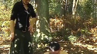 A mature German domina spanks her man in the woods