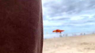 Milf holds my penis tightly in her hand until I cum right on the beach
