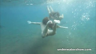 Julia and Masha are swimming nude in the sea