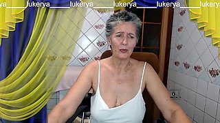 Hot housewife Lukerya with a sweet smile flirts happily on a webcam with her fans in the kitchen online