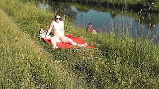 Wild Beach. Sexy Milf Platinum Naked Sunbathing On River Bank, Random Fisherman Guy Watches. Naked In Public. Nude Beach