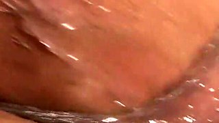 Oiled slut fisted up her butt and cunt