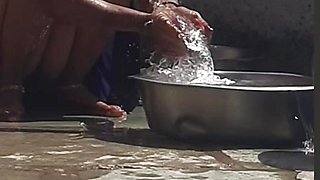 Desi sister-in-law is taking a bath in an open bathroom near the road on the edge of the forest on the farm