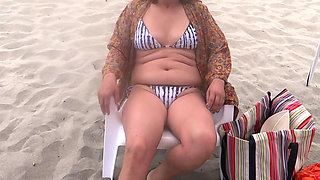 On the Beach, Stepmom Shows off and Loves Making Cocks Hard