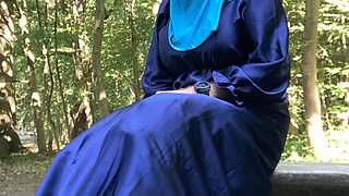 Fatima masturbates on a bench in the forrest