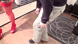 Giant tattooed redhead walks her slave around the room while smoking
