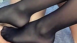 Sensual Closeup View Footjob with Black Nylon Stokings