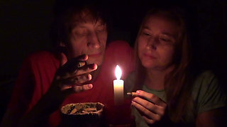 Couple Smoke Next to Candle