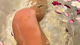 Bath of Blossoms Naked MILF Masturbates Among Flowers