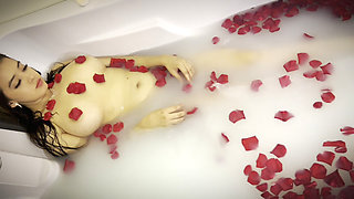 a milk shower with roses, and playing with her feet