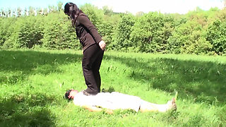 Outdoor trampling punishment with muddy shoes
