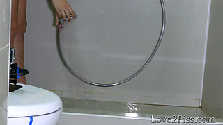 Desperate nude brunette empty her bladder in the bathroom