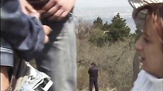 Girl in white takes on a hillside gangbang