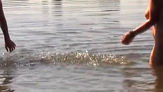 A beautiful busty brunette invites her boyfriend to fuck in the lake.