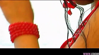 Brunette in Red Bikini Seduces Tattooed Man on Boat Deck