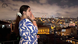 Smoking on the Balcony with a City View