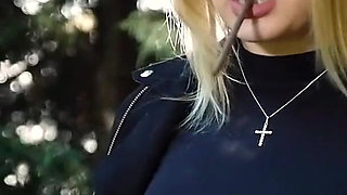 Hot Blonde Babe Smoking Two Black Cigarettes in Nature
