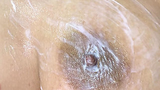 Mom massages her tits big with delicious cream