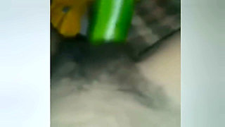 A Young Woman Is Inserting a Cucumber Into Her Pussy